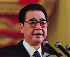 FILE - In this March 5, 1996 file photo, Chinese Premier Li Peng delivers his work report at the opening session of the National Peoples Congress, the annual meeting of the legislature, in Beijing's Great Hall of the People. When Li suddenly canceled a meeting with the Philippine president in 1993, the excuse the government gave was that he had a cold. Over the next four months, Li made only two public appearances. At one of them he confessed to a minor heart condition. When he resurfaced in August, it was on the front page of newspapers, standing in swim trunks with his hands on his hips. China scholars later wrote that Li had suffered a heart attack. Some accounts say it was preceded by scathing criticism from party elders. Li outlasted his rivals, clinging to power until 2003 after 16 years in the leadership. (AP Photo/Greg Baker, File)