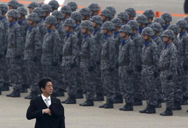 Japan's Prime Minister Shinzo Abe reviews members of Japan Self-Defense Force (JSDF) during the JSDF Air Review, to celebrate 60 years since the service's founding, at Hyakuri air base in Omitama, northeast of Tokyo, in this October 26, 2014 file photo. REUTERS/Toru Hanai/Files